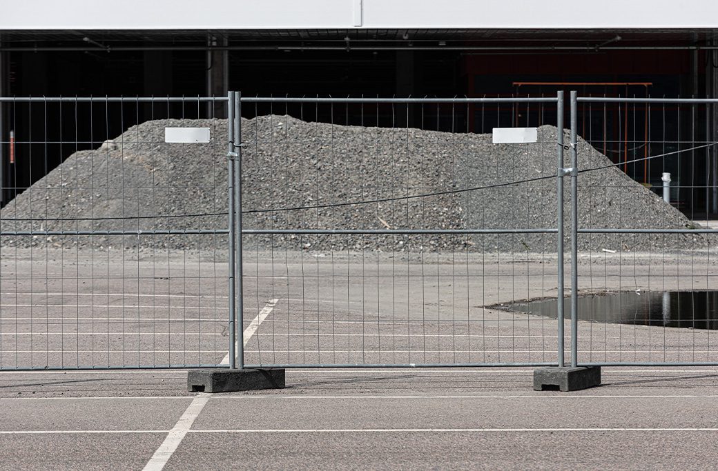 Temporary fencing installed on asphalt with solid rubber footings