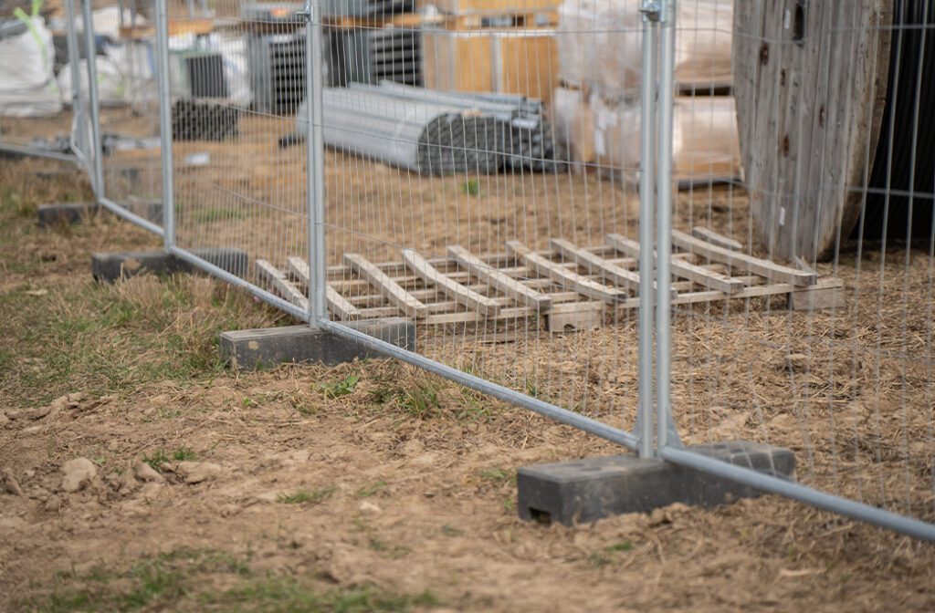Temporary fence panel secured with a rubber footing