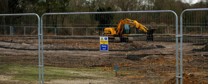 Temporary block and panel fencing surrounding a construction site
