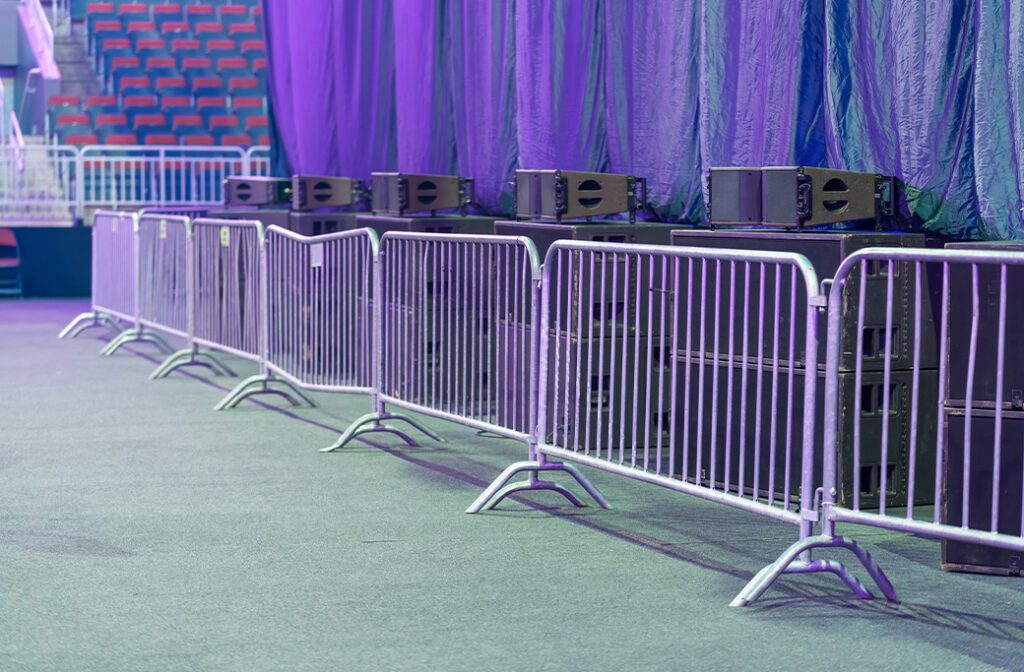 Temporary fencing installed on pavement for an indoor event