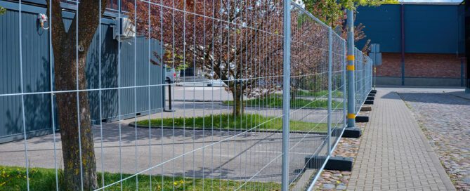 Temporary fence rental installed around a New England construction site
