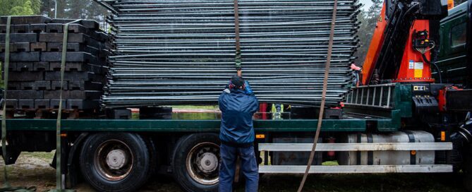 Mobile Fencing crew delivering and installing temporary fencing